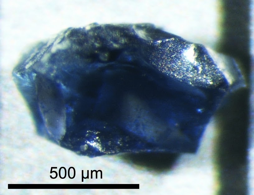 Single crystal of a synthetic high-pressure mineral (blue crystal, 500 micrometre scale)